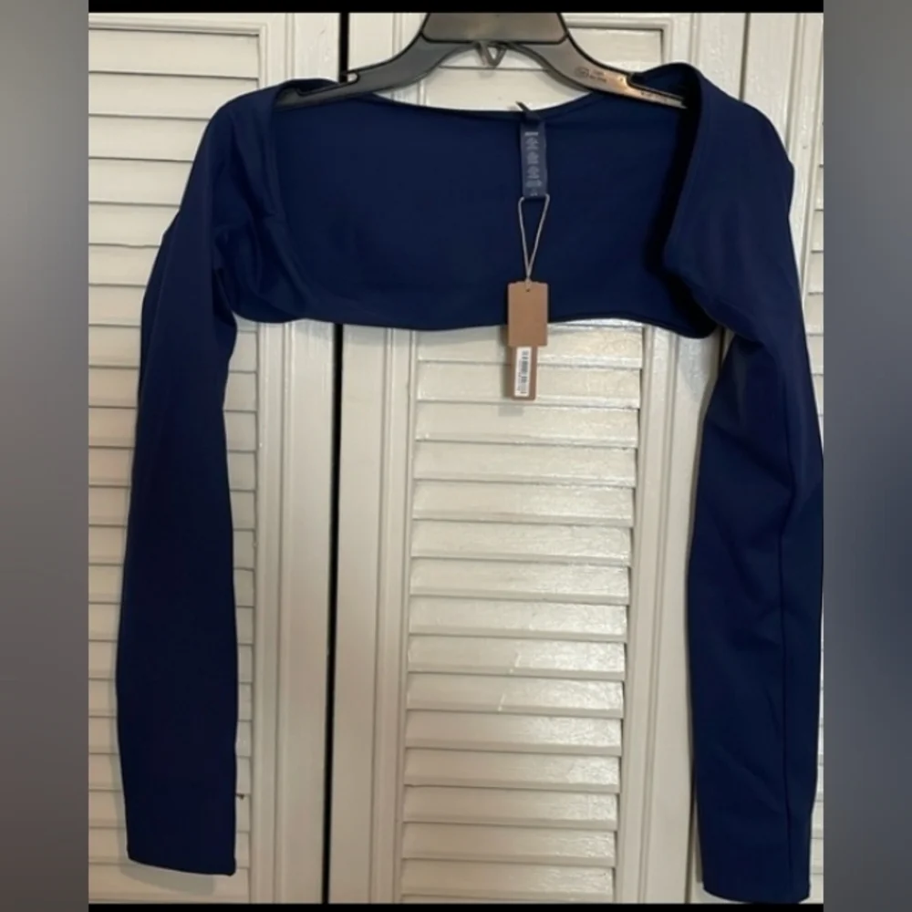Skims sculpting swim long sleeve shrug.
